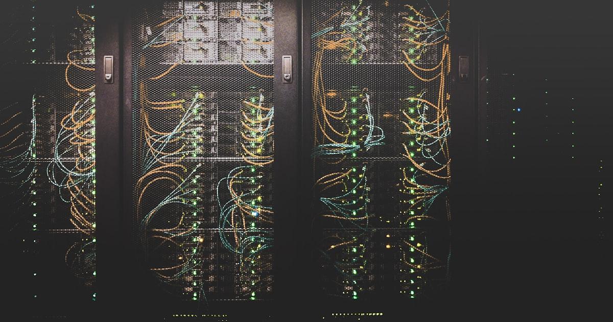 Elon Musk at a tech conference with SpaceX and xAI logos